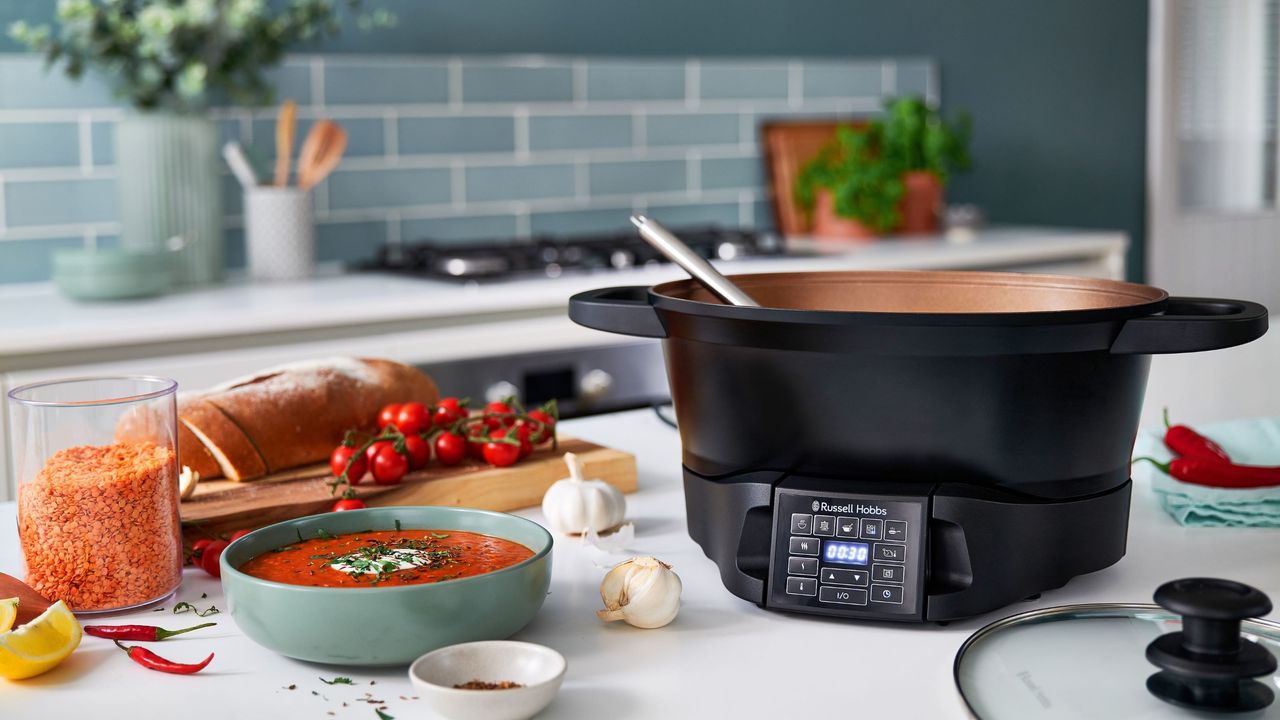 Black Russell Hobbs multi cooker next to food on white kitchen worktop