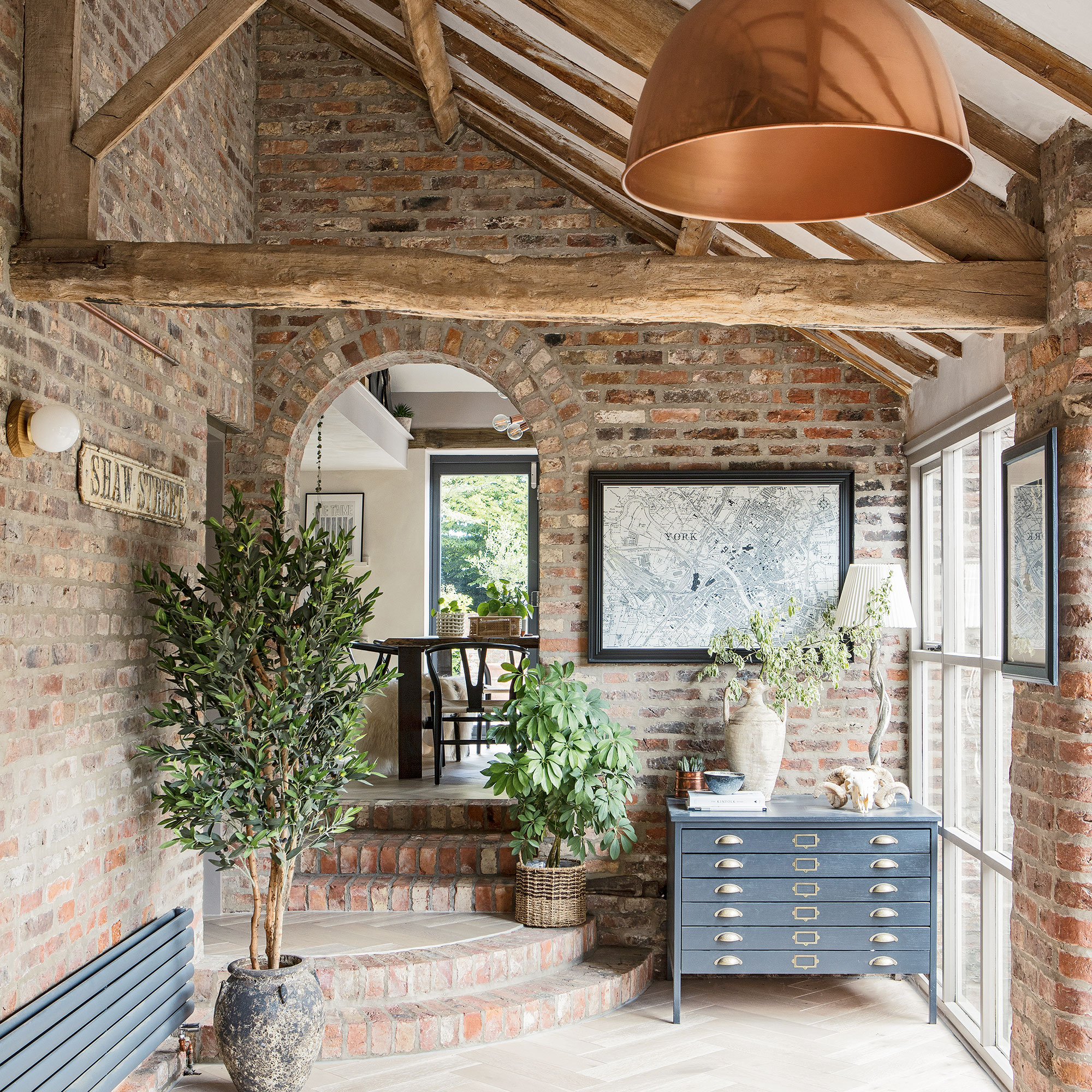 hallway with brick wall and plants