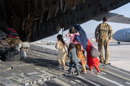 U.S. soldier & Afghan civilians.