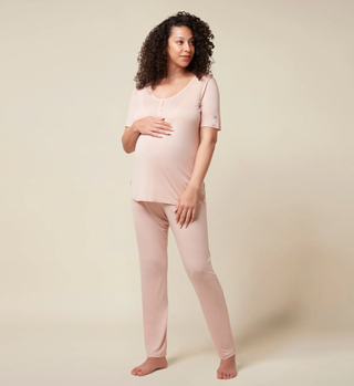 Pregnant woman in pink maternity pyjamas
