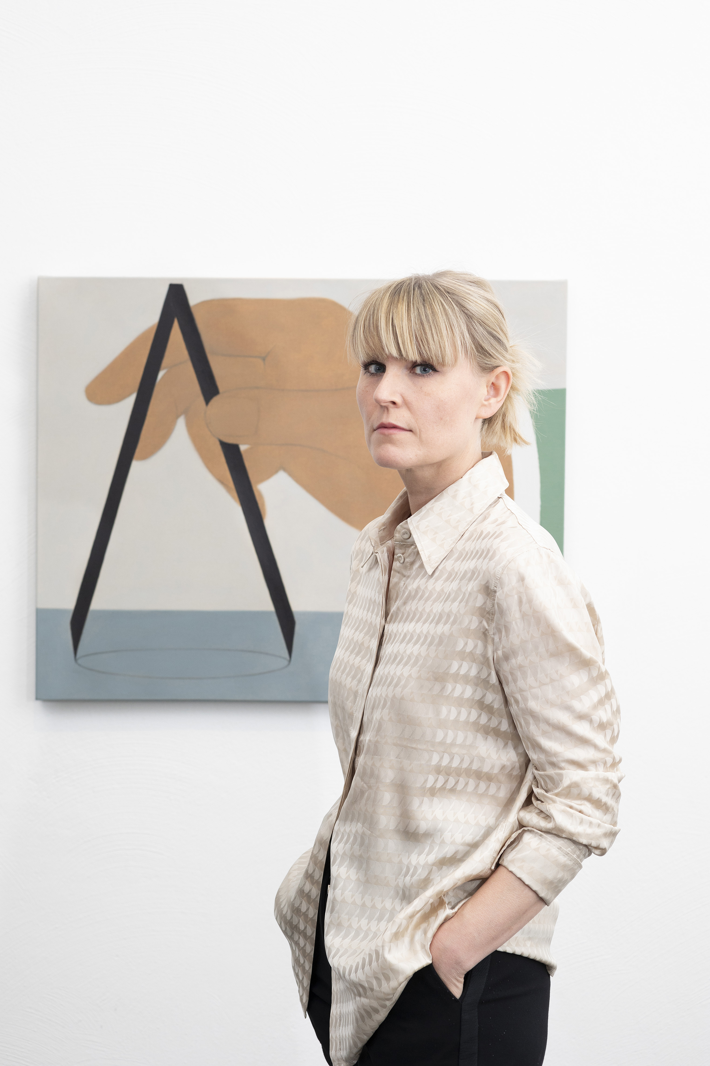 Artist Henni Alftan beside one of her artworks