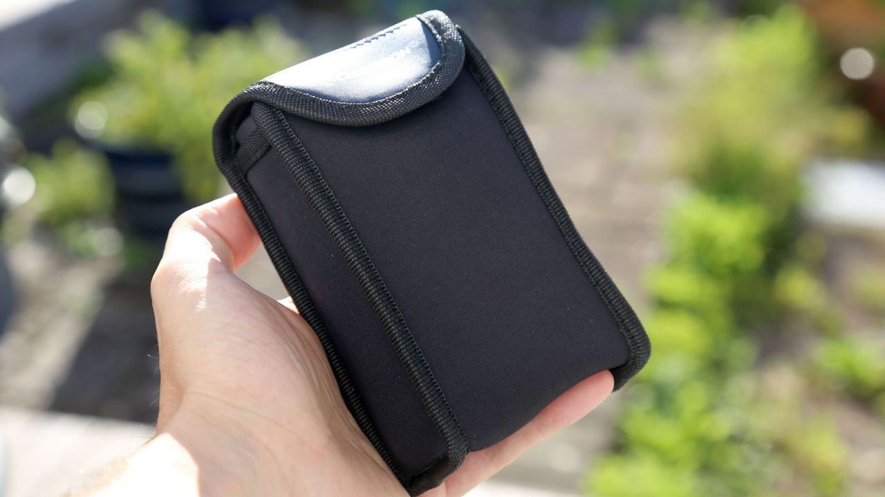 The carry bag of the Eclipsmart 10x25 in the author's hand