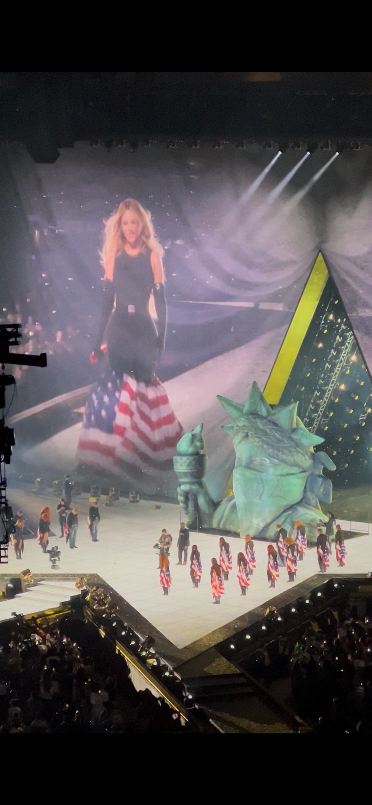A birds-eye view of the Cowboy Carter tour closer, with Beyoncé and backup dancers wearing American flag costumes and a structure of the Statue of Liberty wearing a mask.