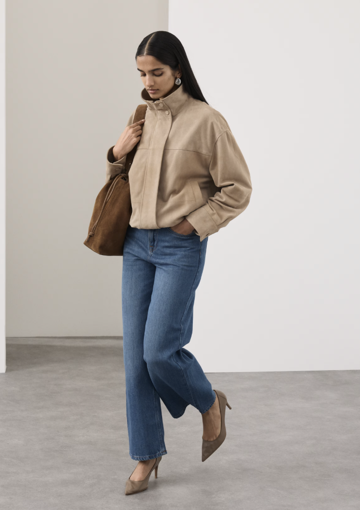 Image of the Marks and Spencer's spring fashion trends 2026. The model wears a tan suede funnel-neck bomber.