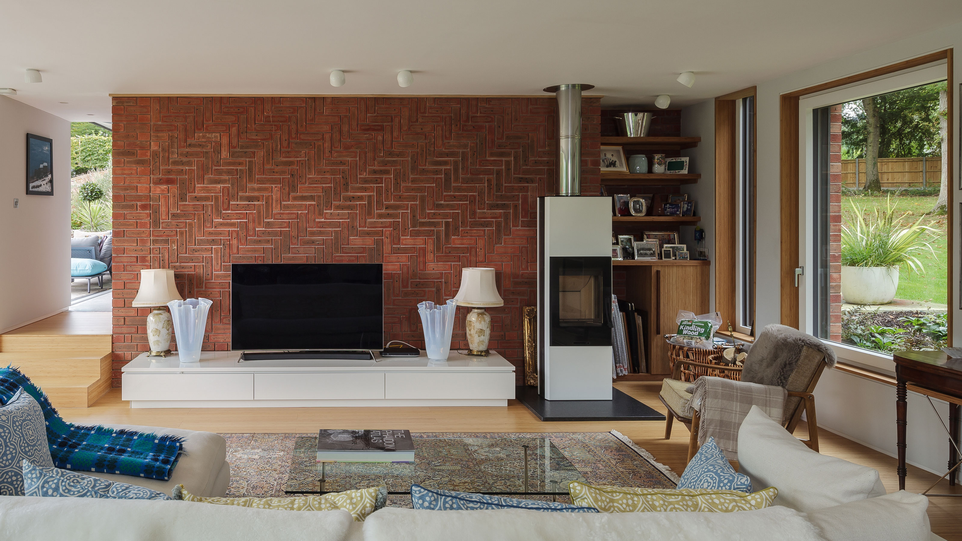 a herringbone brick wall with a stove in front