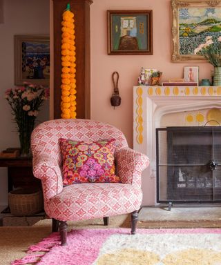 armchair in front of fireplace with painted detail