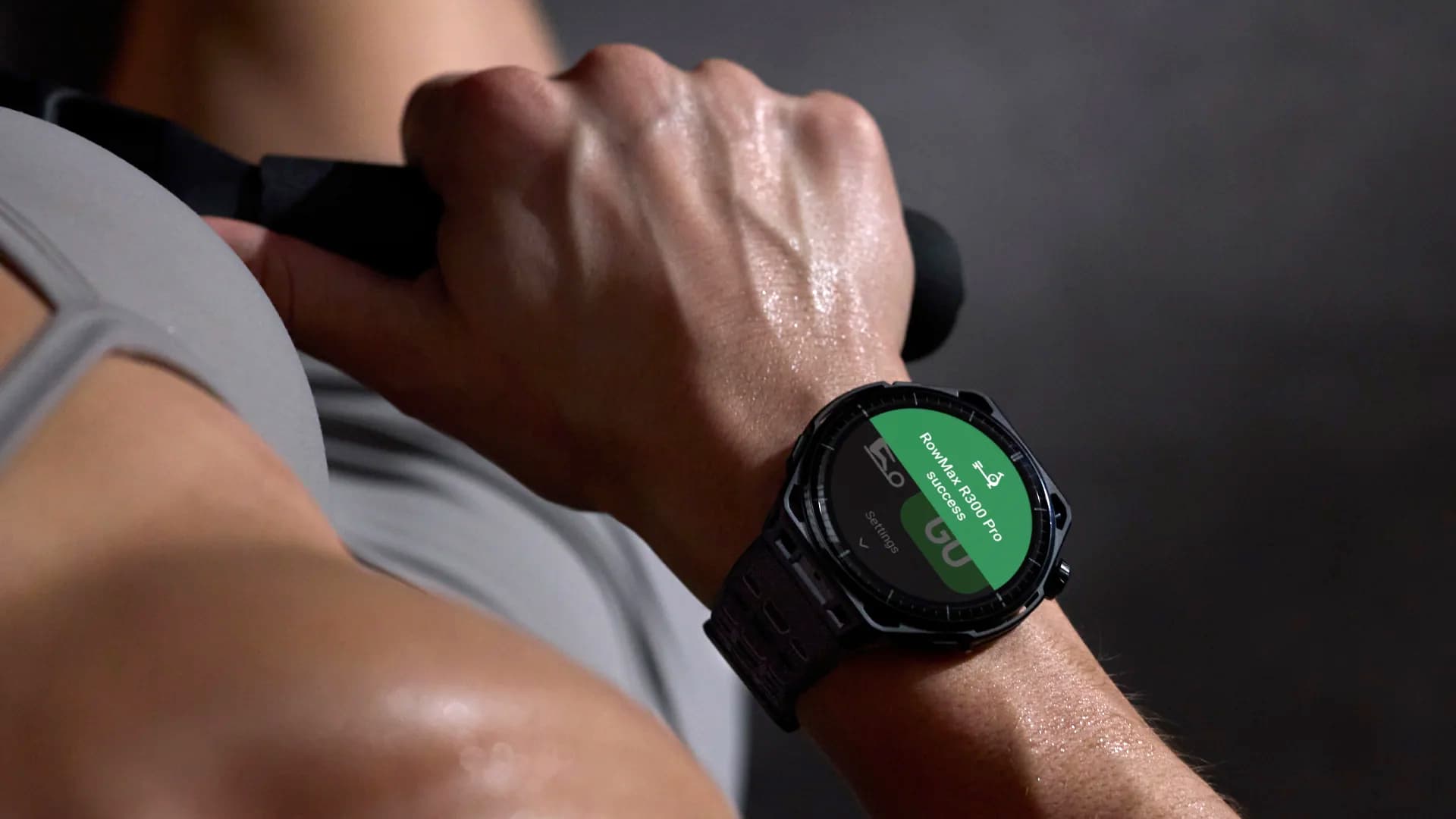 A person using the Amazfit Balance 3 smartwatch on an indoor rowing machine.