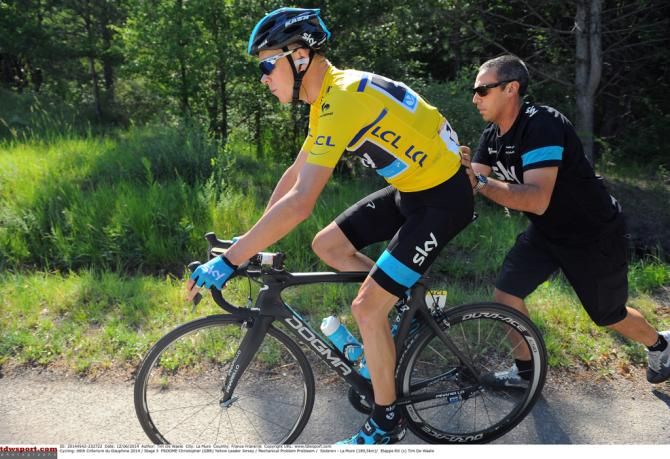 Chris Froome gets a hand after a flat