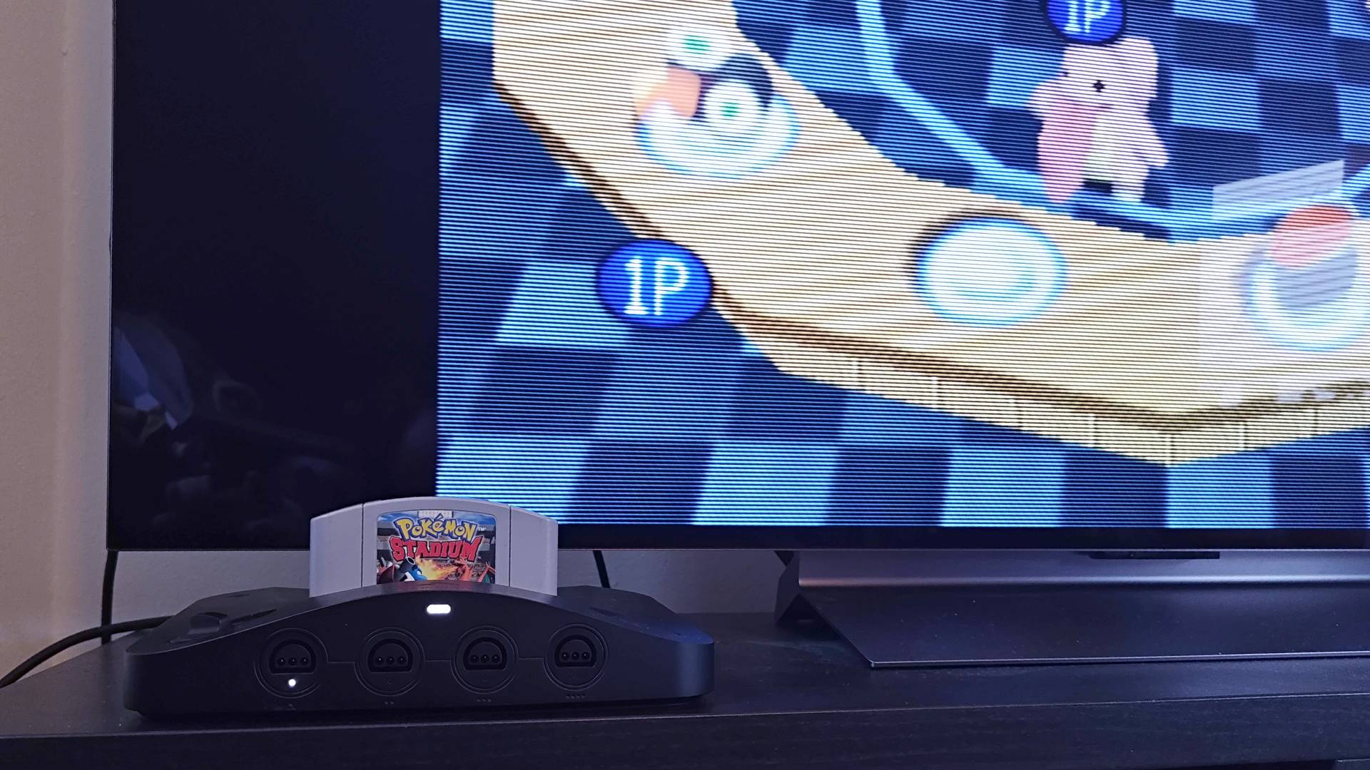 Analogue 3D connected to LG OLED TV with Pokemon Stadium Lickitung mini game on screen.