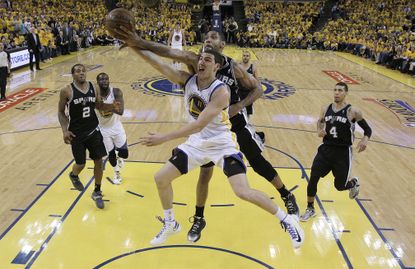 San Antonio Spurs' Tim Duncan blocks a shot by Golden State Warriors' Klay Thompson.