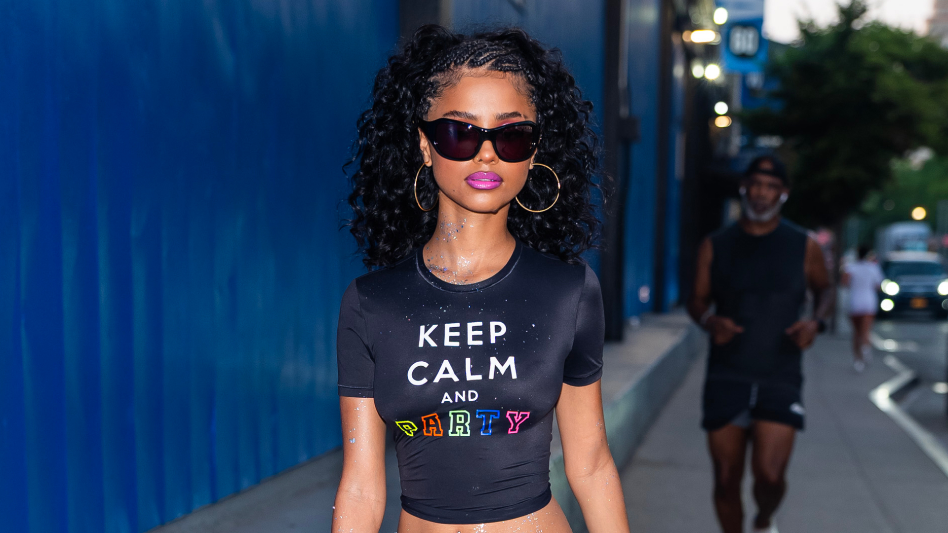 Tyla wearing sunglasses and a cropped t-shirt