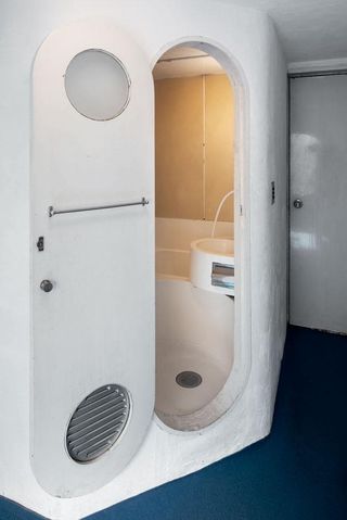 compact bathroom with small bathtub