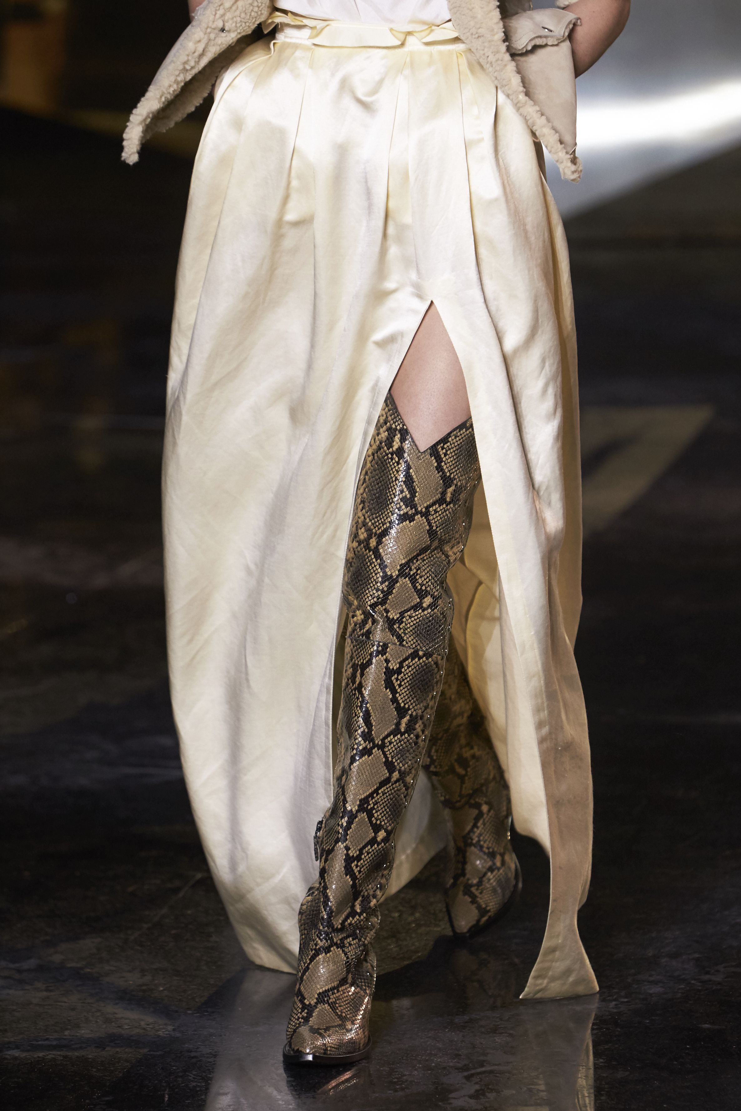 Closeup of a model's python print boots.