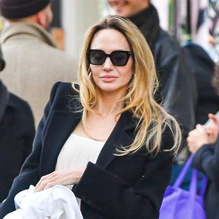 03/07/2025 Angelina Jolie is pictured leaving her store in New York City. The American actress wore a black blazer, white blouse, black trousers, and matching heels.