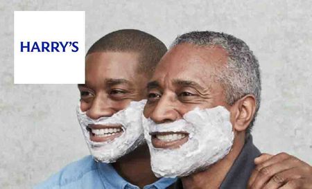 Harry's logo top left with two men smiling with shaving cream on their face