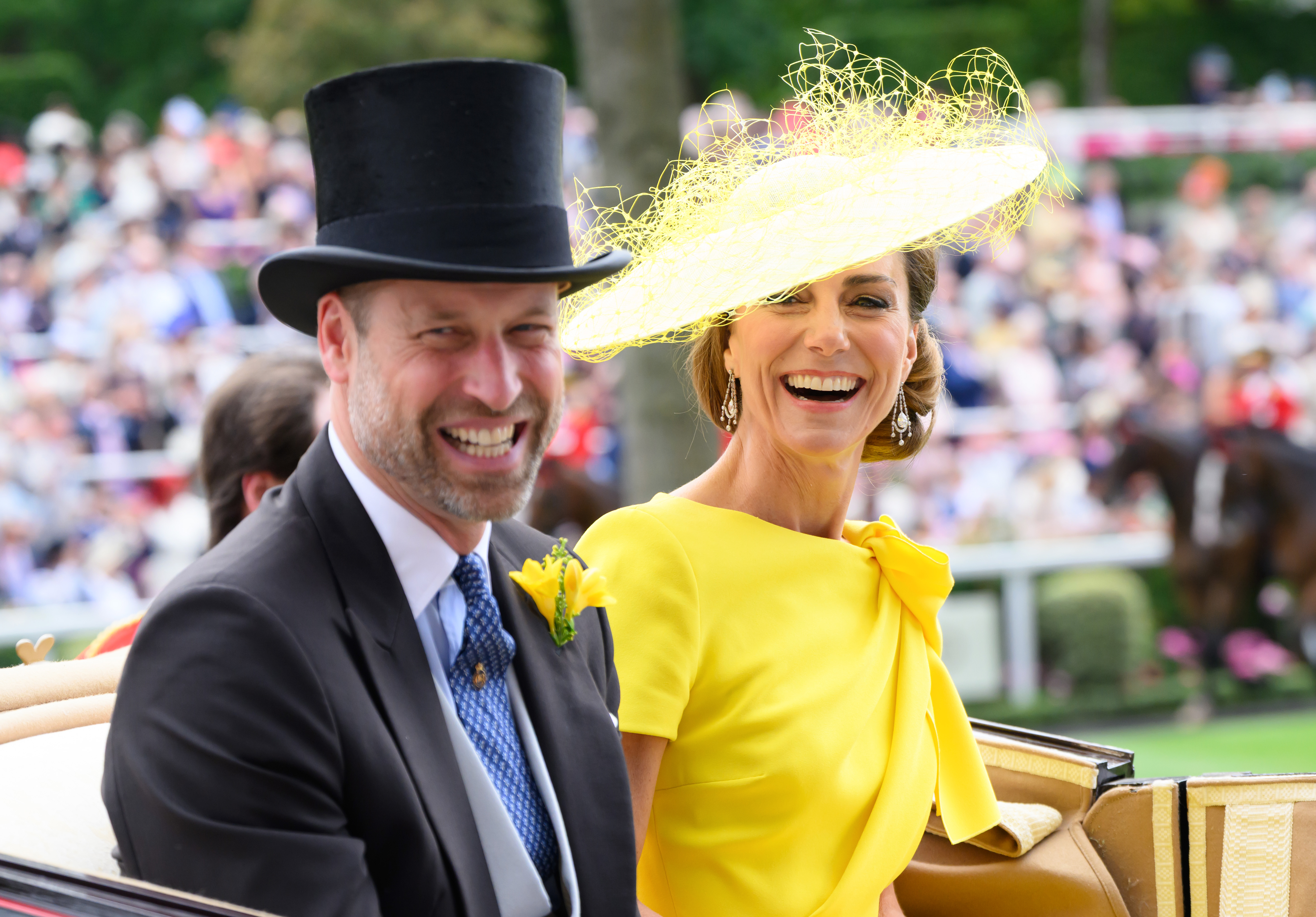 Prince William and Princess Kate laughing in a carriage