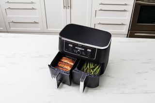 Ninja air fryer cooking salmon and asparagus