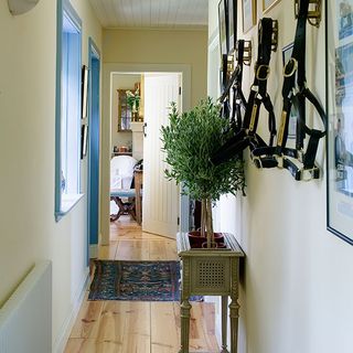 hallway with wooden flooring and photoframes on wall