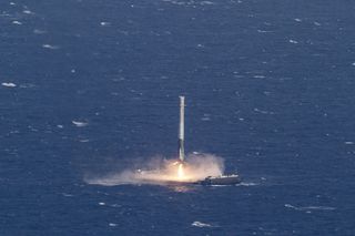 With stunning precision, a SpaceX Falcon 9 rocket touches down on a drone ship landing platform in the Atlantic Ocean after launching a Dragon supply ship into orbit and returning to Earth on April 8, 2016.