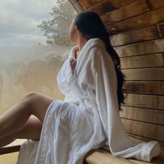 A woman wearing a robe in a sauna