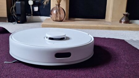 Dreame D9 Max Gen 2 robot vacuum in front of fireplace in reviewer's home