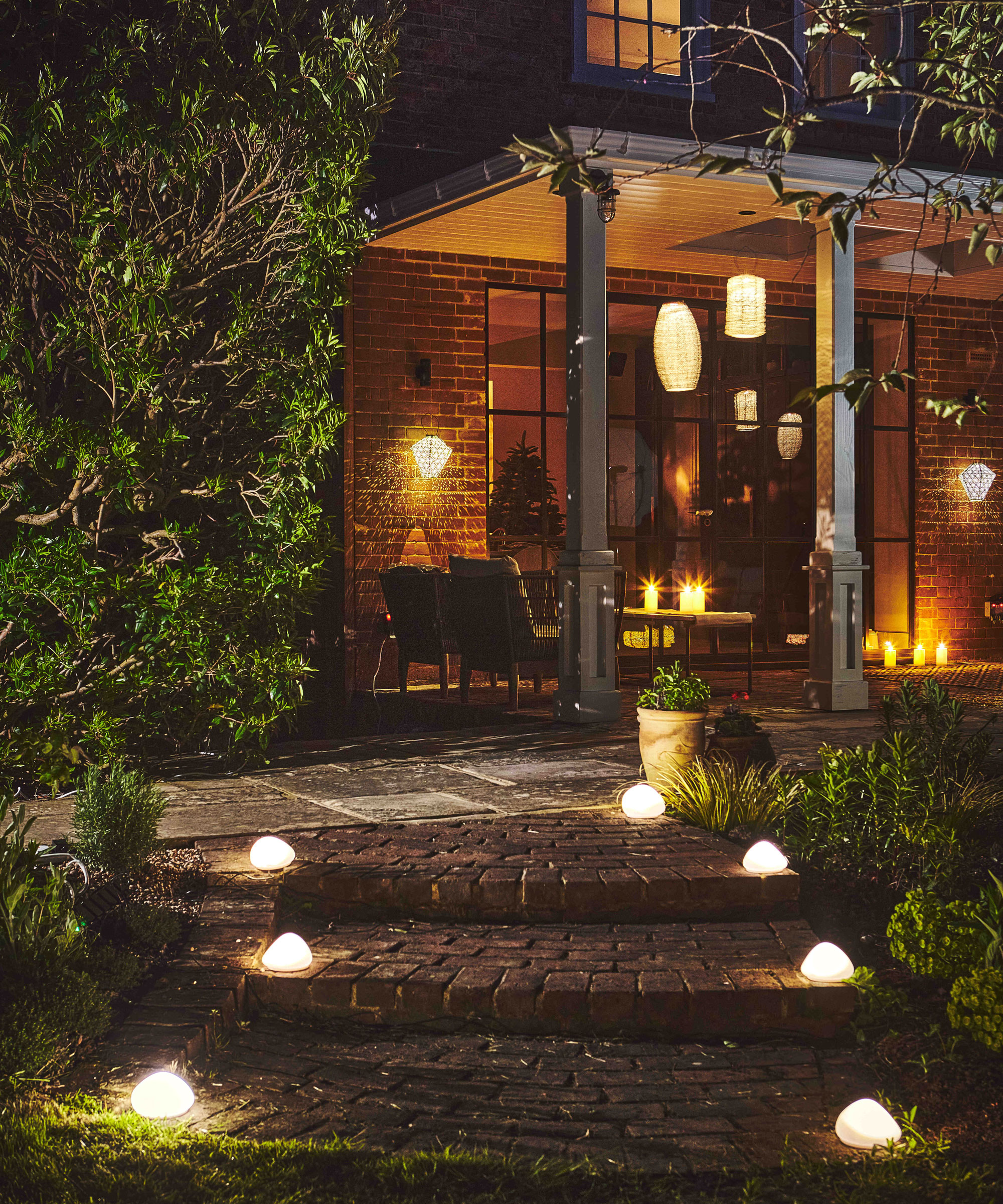 garden path and steps with lights leading to gazebo with garden furniture and lanterns