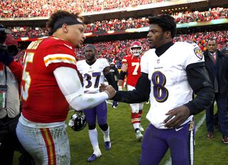 Patrick Mahomes of the Kansas City Chiefs meets the Baltimore Ravens' Lamar Jackson in the middle of the field.