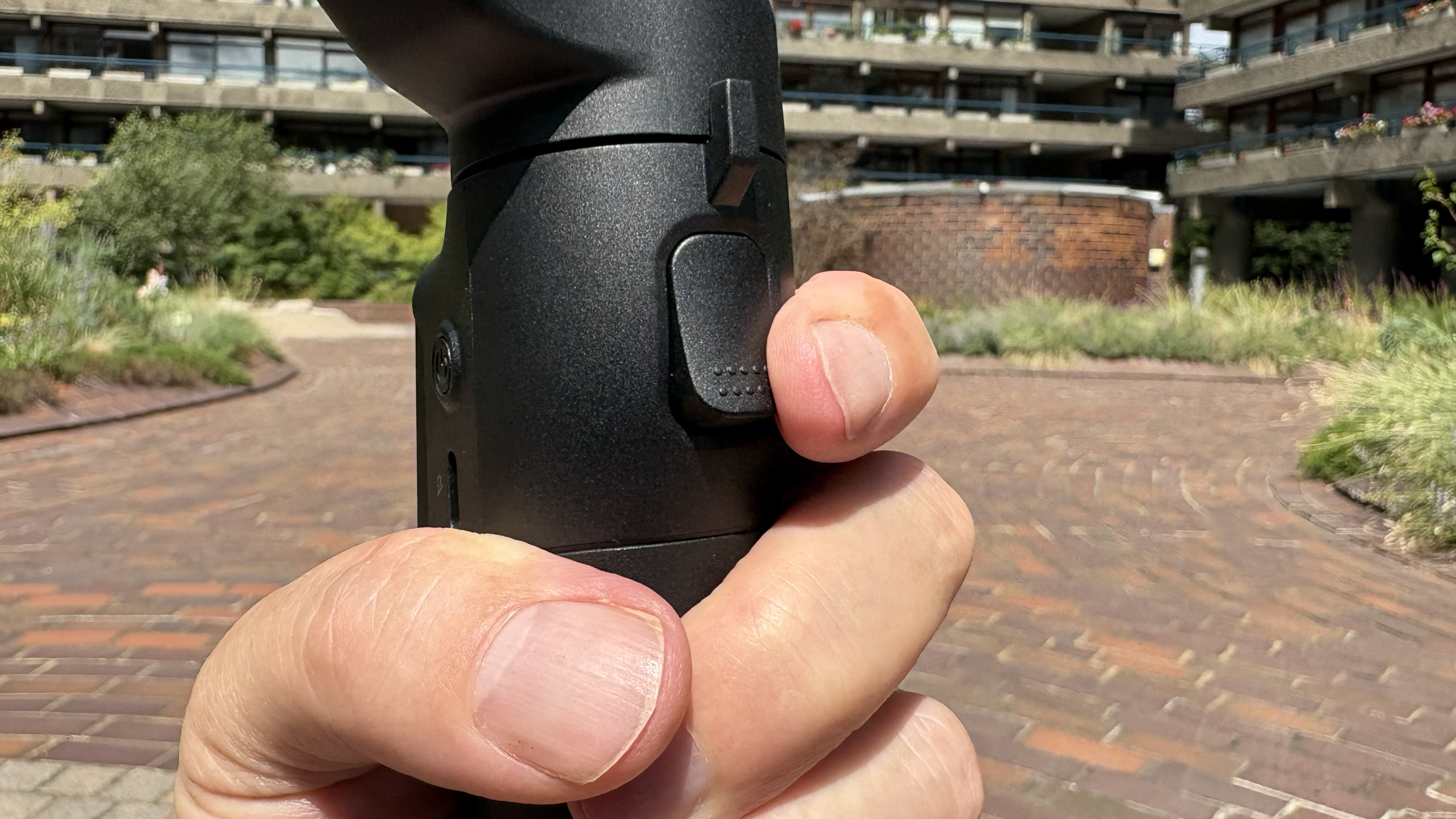 Close-up of a finger on the trigger at the front of the iSteady V3 Ultra.
