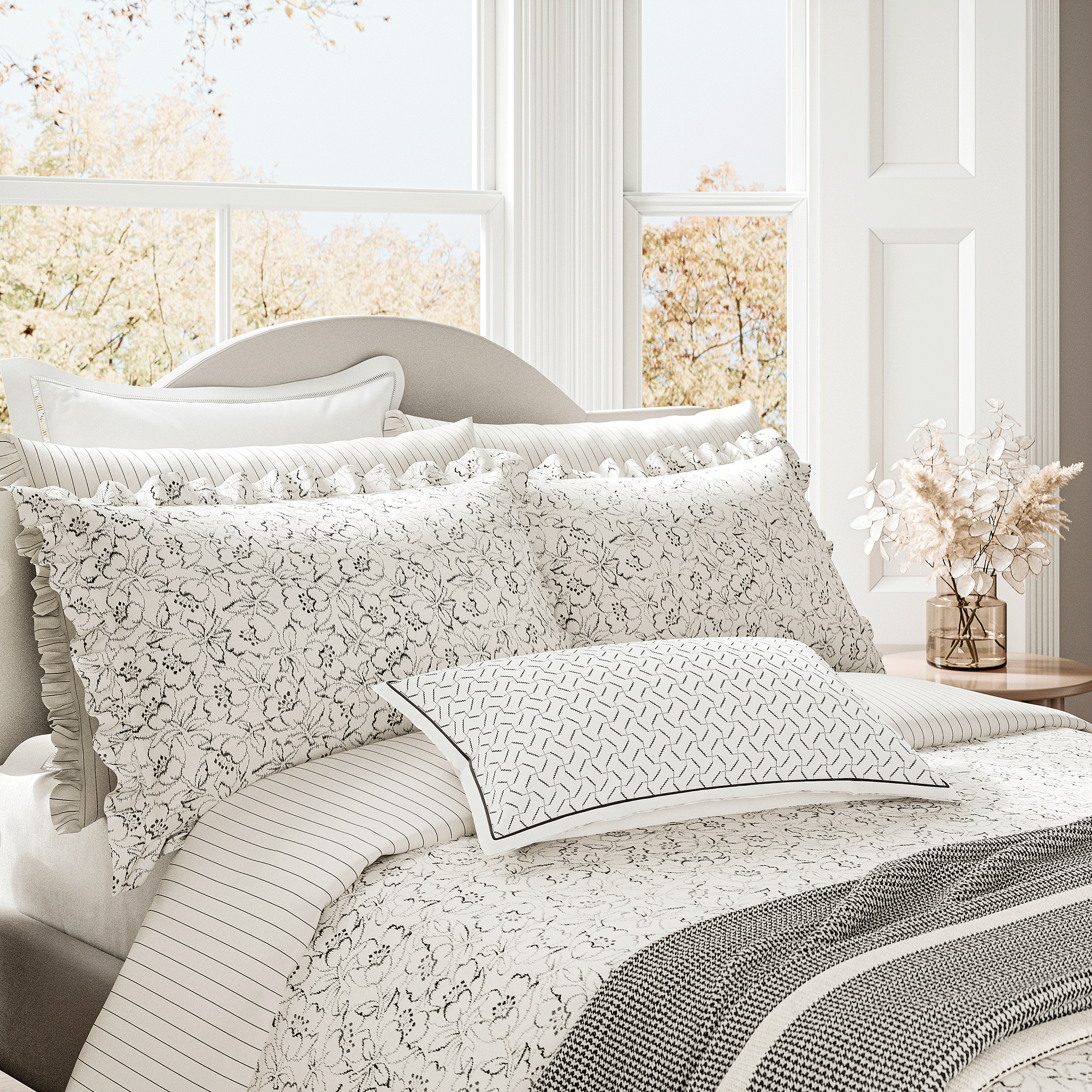 Black line floral white bedding on bed