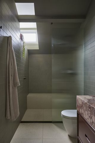 A bathroom with large floor tiles