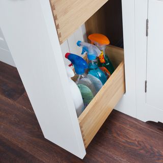 cupboards with pull out drawers and spray bottles