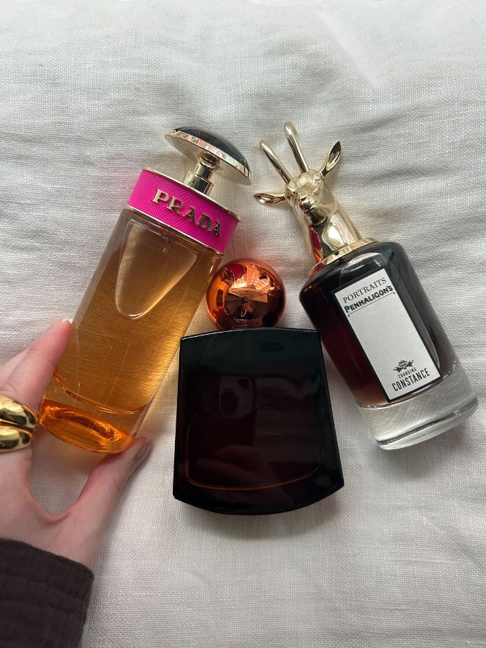 Junior beauty editor Grace Lindsay holding some of the best caramel perfumes