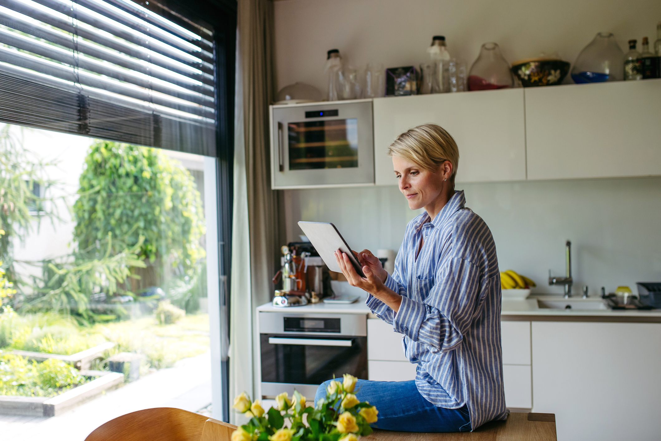 a woman sets temperature control on her tablet