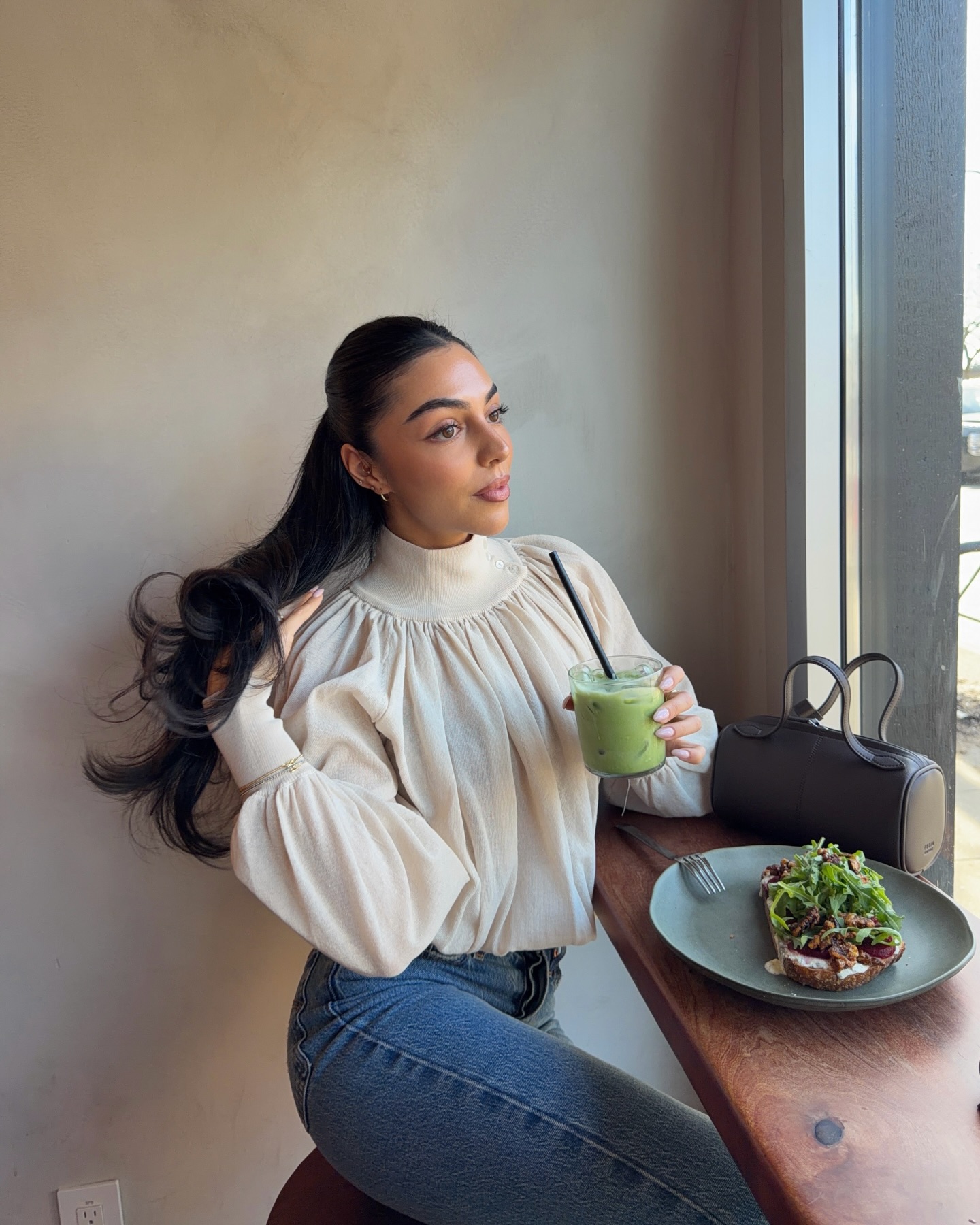 Mobina Peiman with long, shiny hair pulled into a half up-do