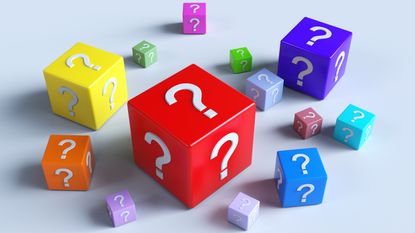 A selection of plastic blocks in multiple colors with question marks on them.