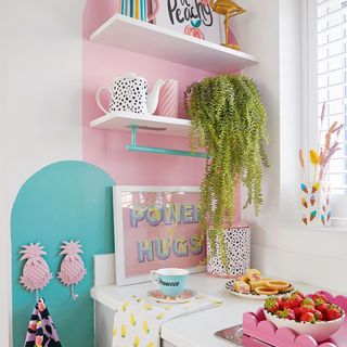 kitchen shelves with pink and green painted wall