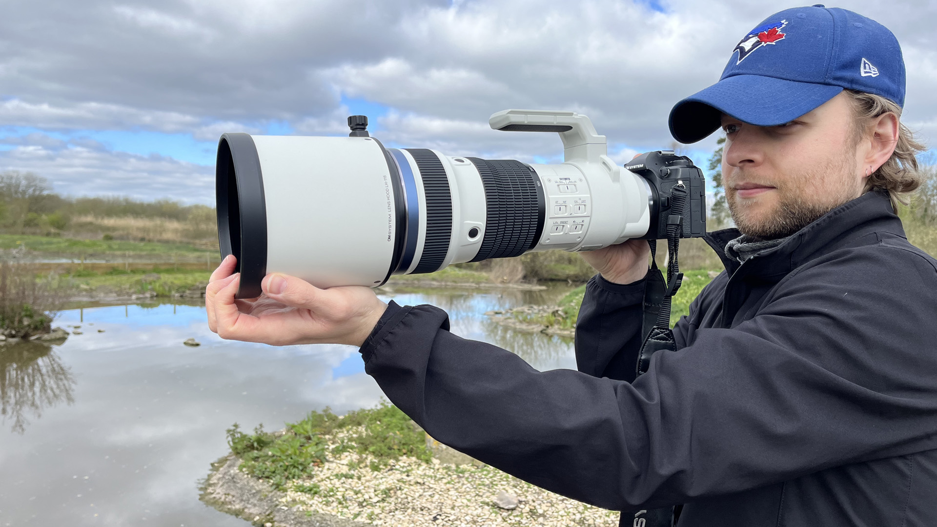 Mike Harris holding OM System M.Zuiko 150-400mm f/4.5 TC1.25x IS PRO at Slimbridge Wetland Centre 