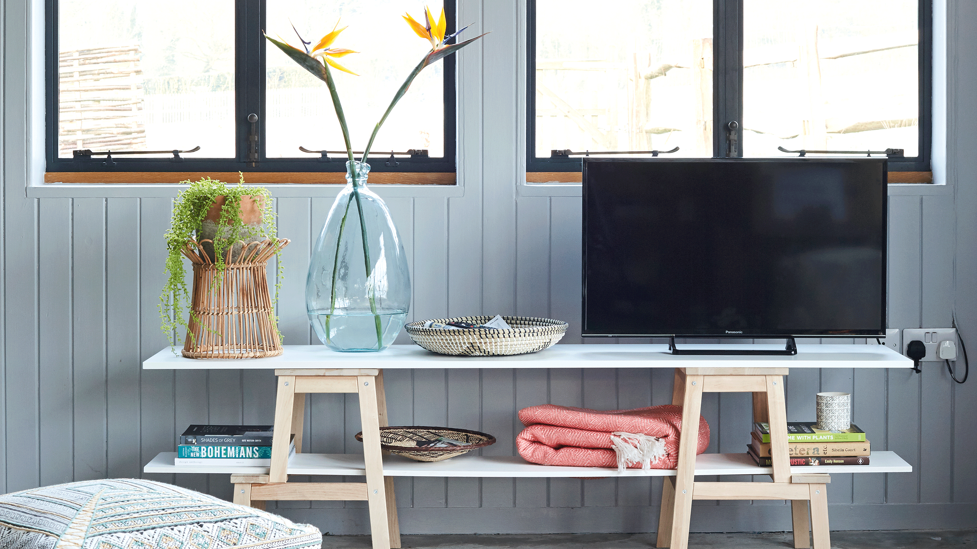 grey media wall with shelves and tv