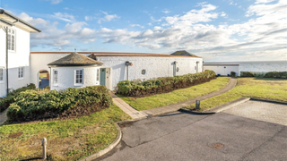 A white painted home with views over the sea