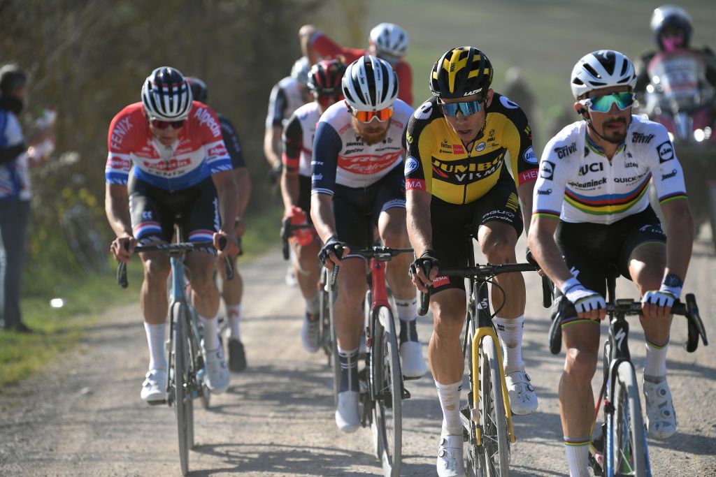 SIENA ITALY MARCH 06 Mathieu Van Der Poel of Netherlands and Team Alpecin-Fenix Quinn Simmons of United States and Team Trek Segafredo Wout Van Aert of Belgium and Team Jumbo Visma Julian Alaphilippe of France and Team Deceuninck QuickStep during the Eroica 15th Strade Bianche 2021 Mens Elite a 184km race from Siena to Siena Piazza del Campo Breakaway Gravel Strokes Dust StradeBianche on March 06 2021 in Siena Italy Photo by Tim de WaeleGetty Images