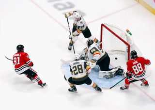 Drake Caggiula #91 of the Chicago Blackhawks (L) scores a first period goal against Robin Lehner #90 of the Vegas Golden Knights in Game Four of the Western Conference First Round during the 2020 NHL Stanley Cup Playoffs at Rogers Place on Aug. 16, 2020 in Edmonton, Alberta, Canada.