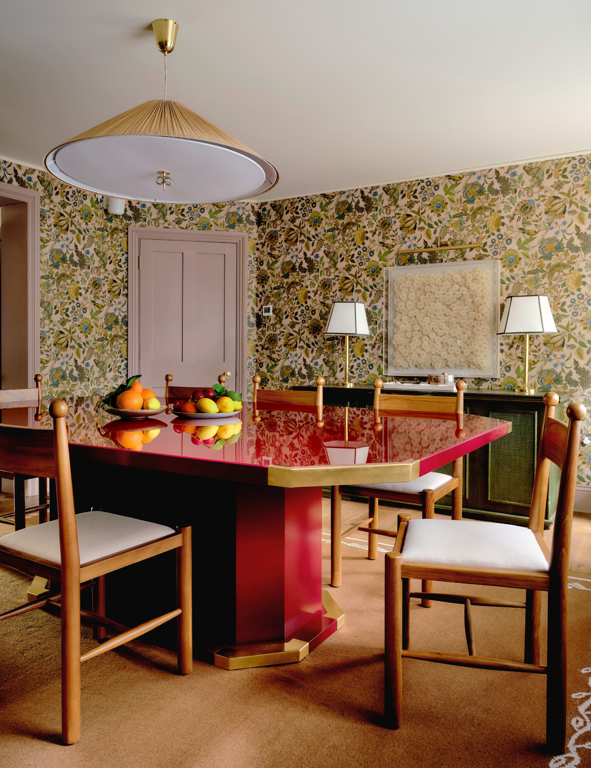 A patterned dining room area featuring a striking red lacquer dining table