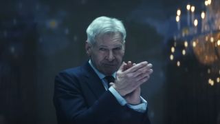 Harrison Ford claps while wearing a knowing expression in Captain America: Brave New World.