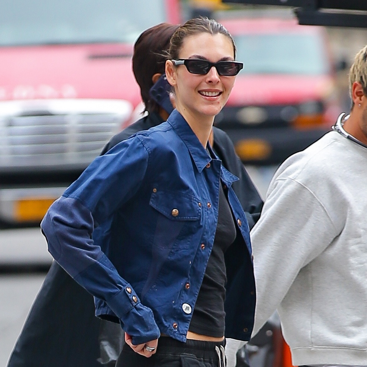 Vittoria Ceretti wearing a navy jacket and black T-shirt with black pull-on pants and butter yellow sneakers in NYC