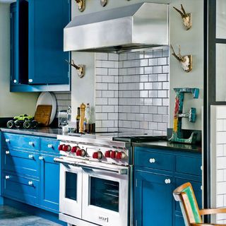 kitchen with gas stove and blue cabinet