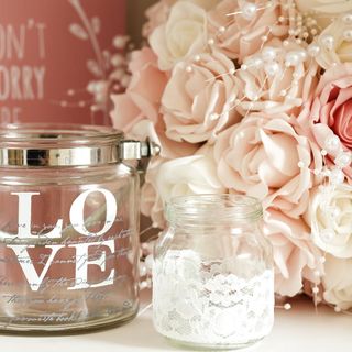 pink coloured rose and glass jar