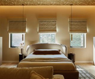 neutral double bedroom with three windows