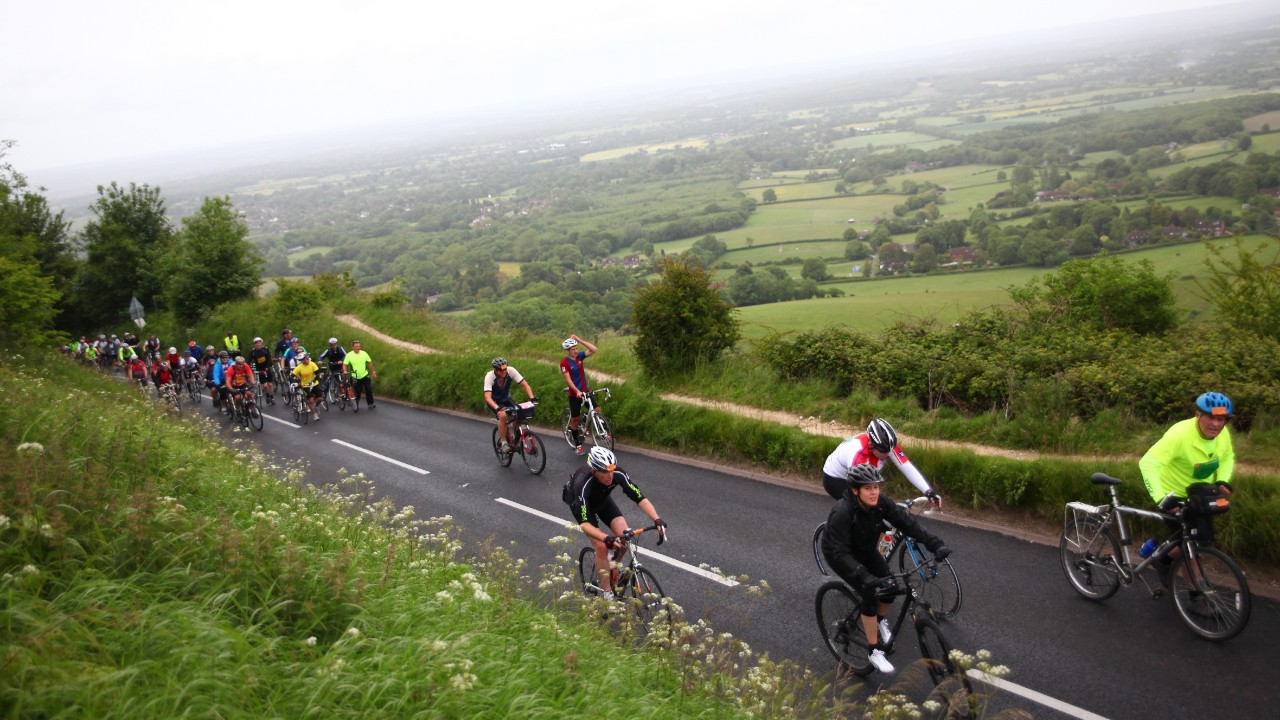 Cyclists climb the notoriously hard Ditchling Beacon during the London to Brighton Bike Ride on June 16, 2013 in Ditchling, England.