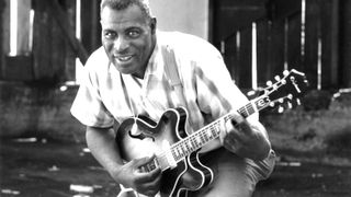 Howlin' Wolf poses for a portrait session holding an Epiphone hollowbody electric guitar behind the Fillmore in July 1968 in San Francisco, California.