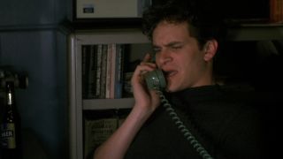 Tom Everett Scott makes a funny face while taking a phone call in That Thing You Do!